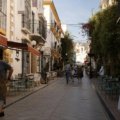 A colorful, sunlit cobblestone street in a historic European city, illustrating travel ideas for the best European cities to visit in 2025.
