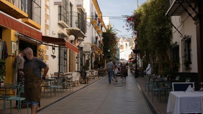 A colorful, sunlit cobblestone street in a historic European city, illustrating travel ideas for the best European cities to visit in 2025.
