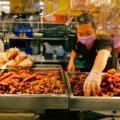 Happy traveler enjoying local street food, representing authentic and affordable travel experiences in the cheapest countries to explore.