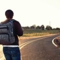 Solo traveler with a backpack enjoying the freedom of exploring a new destination, embodying adventure and self-discovery.