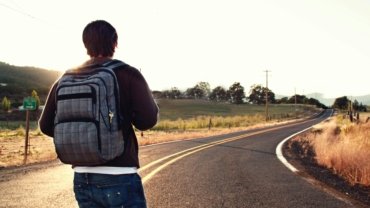 Solo traveler with a backpack enjoying the freedom of exploring a new destination, embodying adventure and self-discovery.