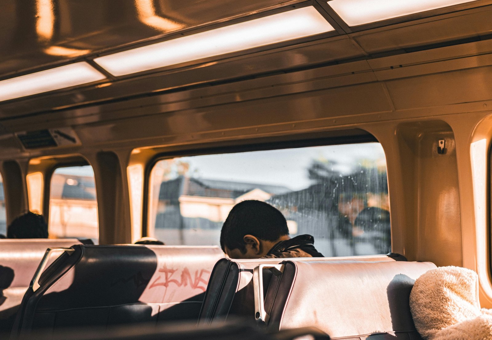 A person enjoying a budget-friendly trip across town on a bus, an example of how to save money for local city exploration.