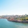 A sunny view of the stunning cliffs and turquoise water of the Algarve coast, illustrating one of the beautiful destinations to consider when deciding the best time to visit Portugal.