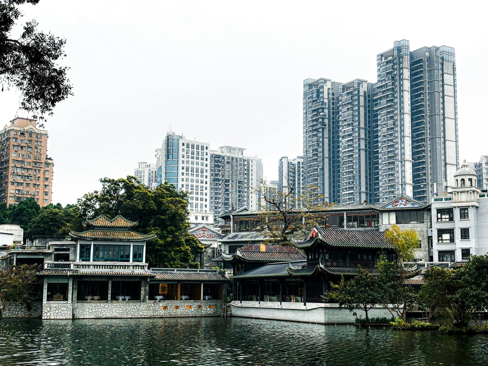 An ancient Chinese temple pagoda overlooks a modern city skyline at dusk, symbolizing the blend of history and innovation for a complete China travel adventure.