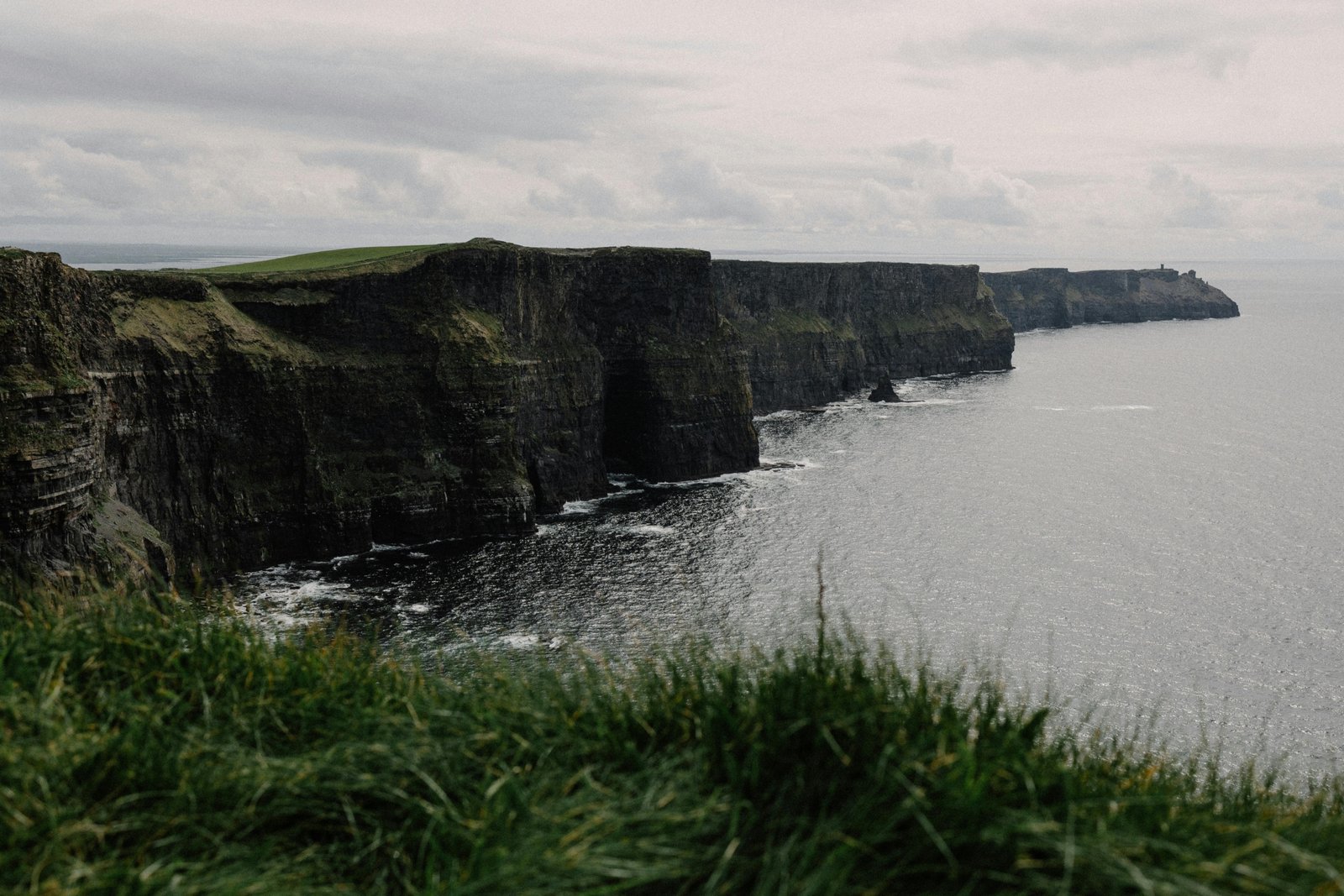 A stunning view of the Cliffs of Moher, one of the best things to see in Ireland, with its dramatic green cliffs overlooking the Atlantic Ocean on a trip in 2025.