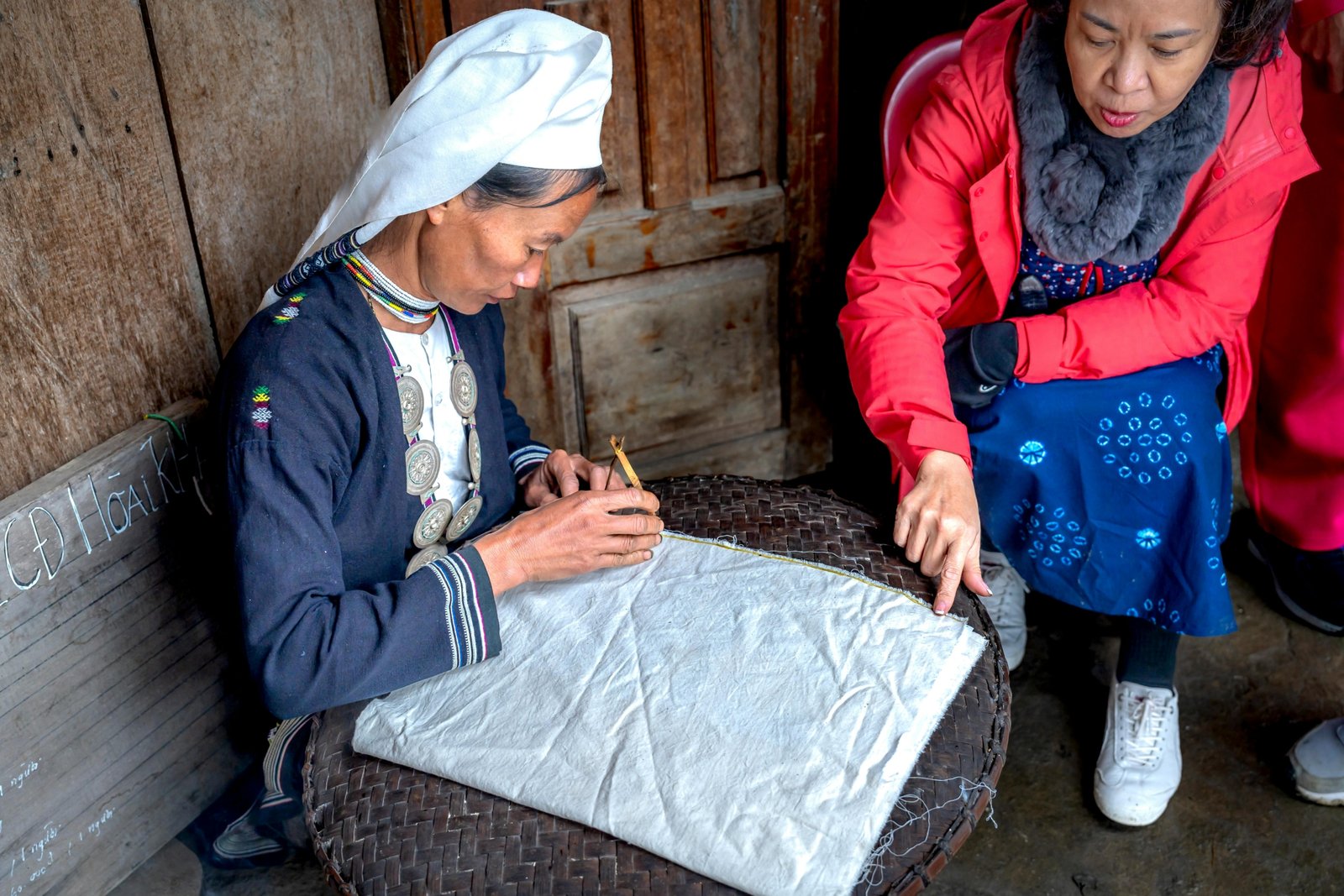 A traveler learning a traditional craft from a local artisan, an example of an authentic and unique cultural immersion experience.