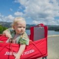 Best travel cot for baby: happy family on vacation with baby sleeping safely in a portable crib for comfortable travel.