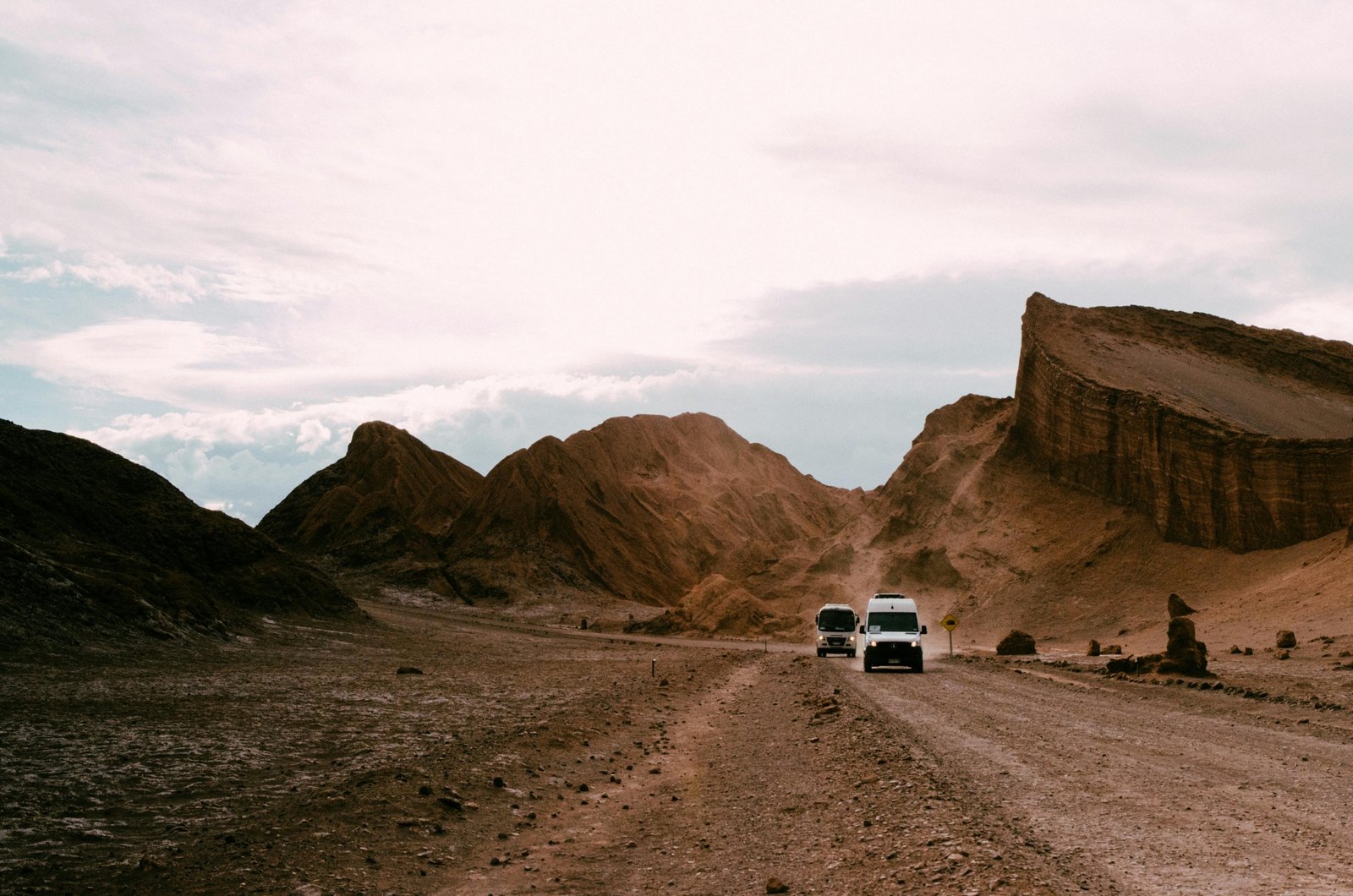 A spectacular sunset paints the otherworldly landscape of the Valle de la Luna in vibrant reds and oranges, a must-see stop on Atacama Desert Chile tours.