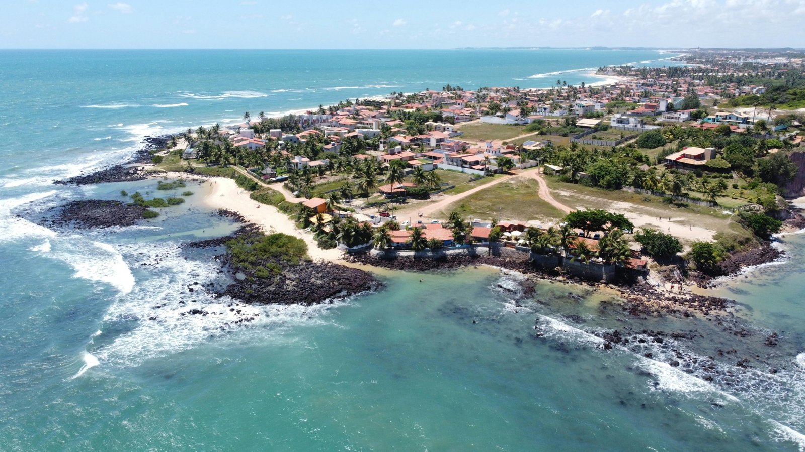An aerial view of a pristine South Padre Island beach with turquoise water, illustrating one of the best things to do in south padre island: enjoying the stunning coastline.