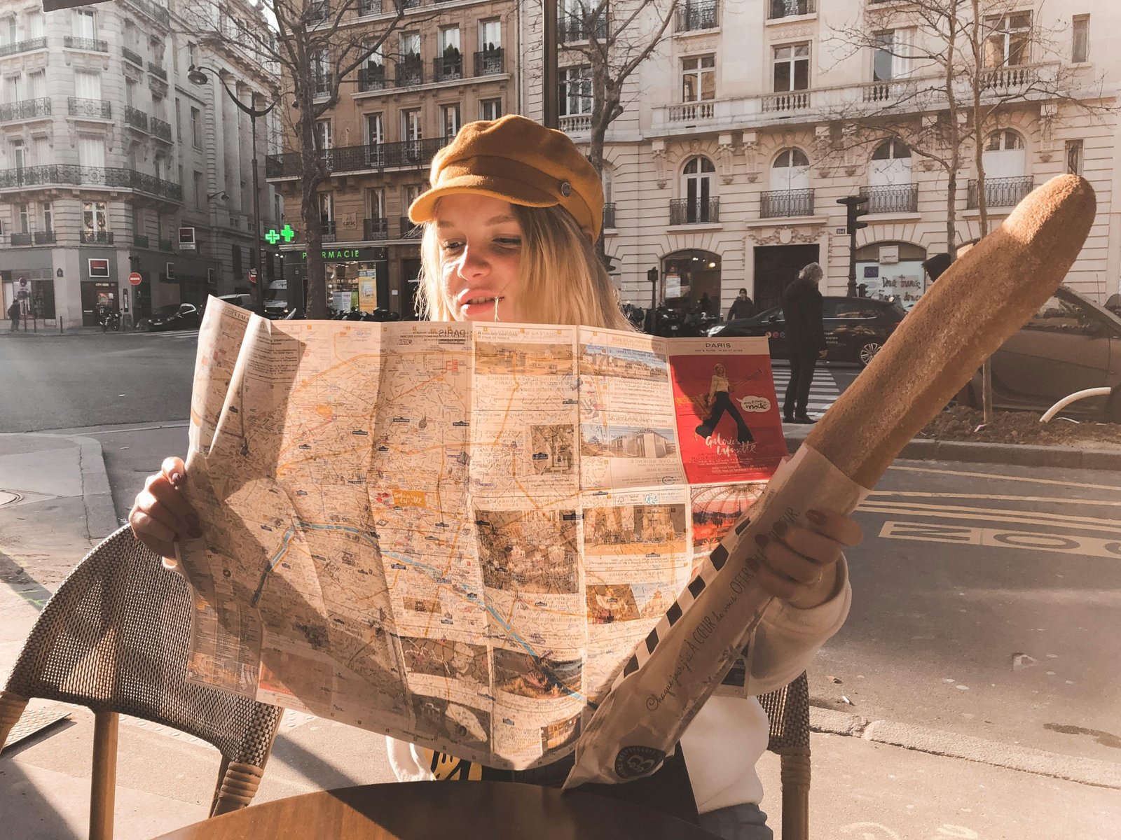 A traveler holding a map on a charming cobblestone street, planning their adventure to the best cities to travel in Europe in 2025.