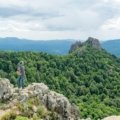 Solo traveler stands in a beautiful natural landscape, embodying the freedom, safety, and enriching discovery of solo holiday packages.