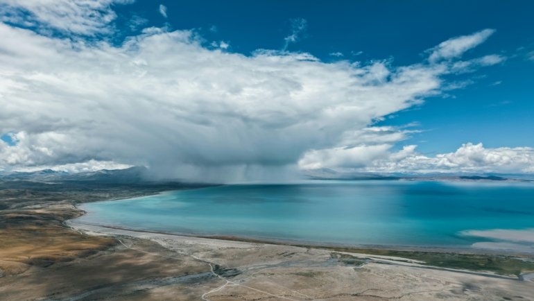A stunning montage of diverse natural landscapes, including a mountain, beach, and forest, illustrating a tier list guide for choosing the perfect travel destination.