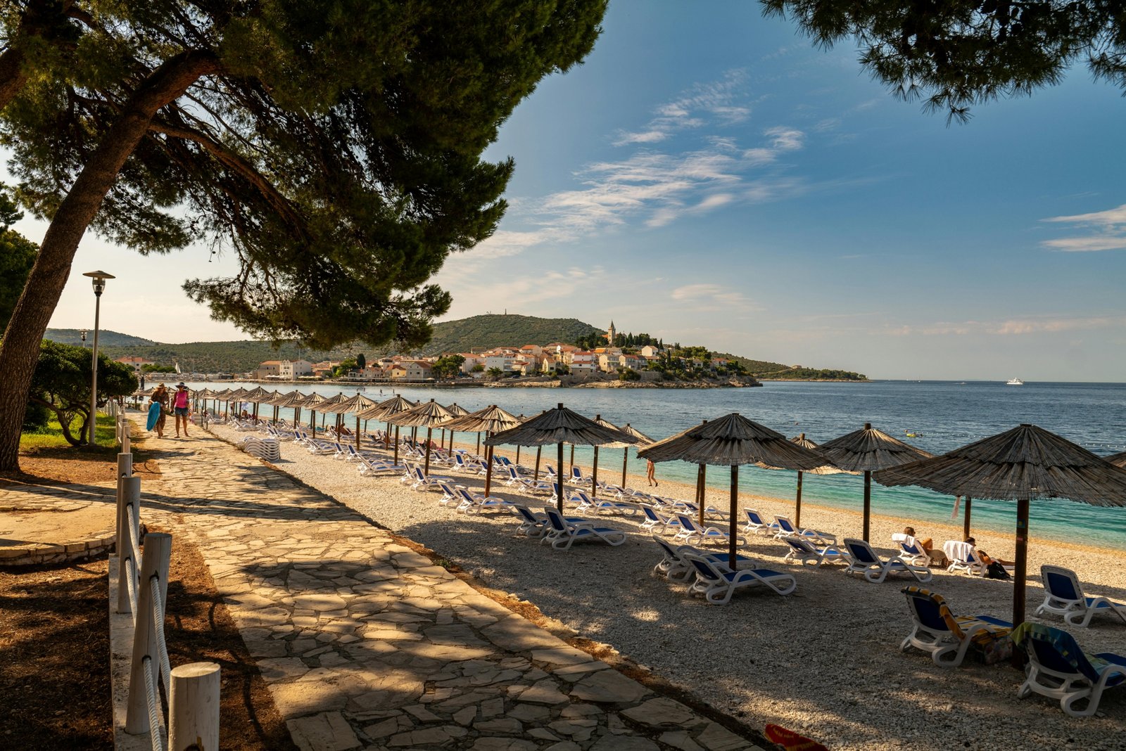 A collage showcasing the best countries to travel to in December, contrasting a sunny tropical beach with a magical snow-covered village at Christmas.