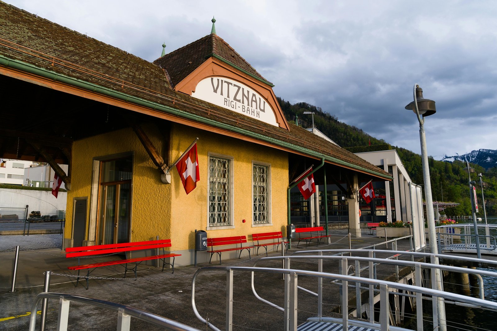 Panoramic view of a scenic Swiss travel package destination, featuring majestic Alps, a tranquil lake, a charming village, and an iconic train, highlighting diverse and convenient exploration.