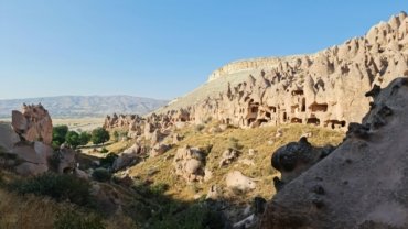 Best budget travel destinations for 2025, showing a traveler enjoying an affordable adventure in a scenic location.