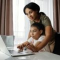 Parent and student accessing the Infinite Campus Sequoia student information system on a laptop, demonstrating easy online access to grades, assignments, and school communication features.
