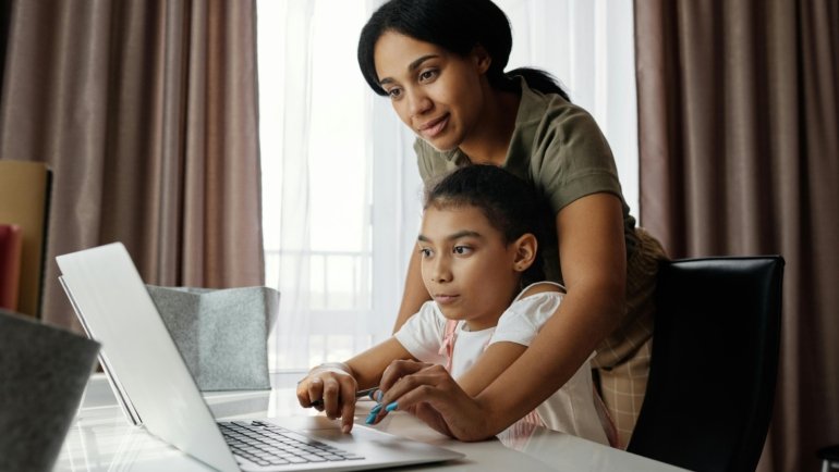 Parent and student accessing the Infinite Campus Sequoia student information system on a laptop, demonstrating easy online access to grades, assignments, and school communication features.