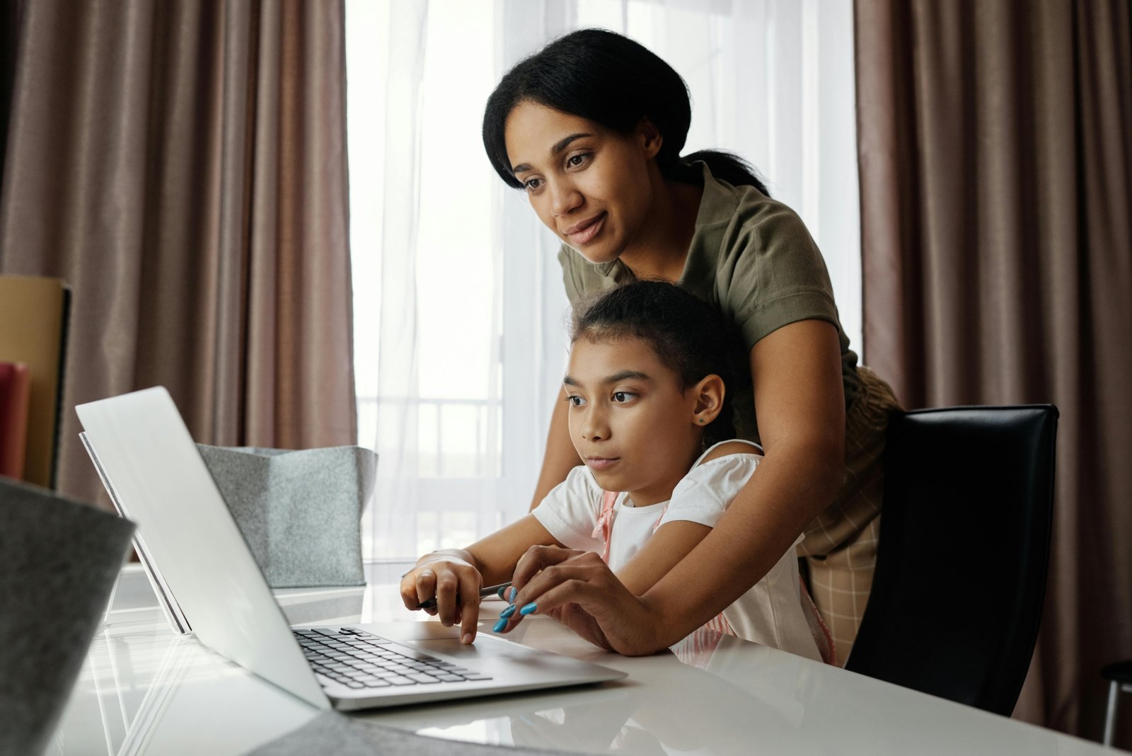 Parent and student accessing the Infinite Campus Sequoia student information system on a laptop, demonstrating easy online access to grades, assignments, and school communication features.