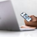 Traveler confidently planning a Bali trip on a laptop, accessing an online travel forum for real-time advice and itinerary planning.