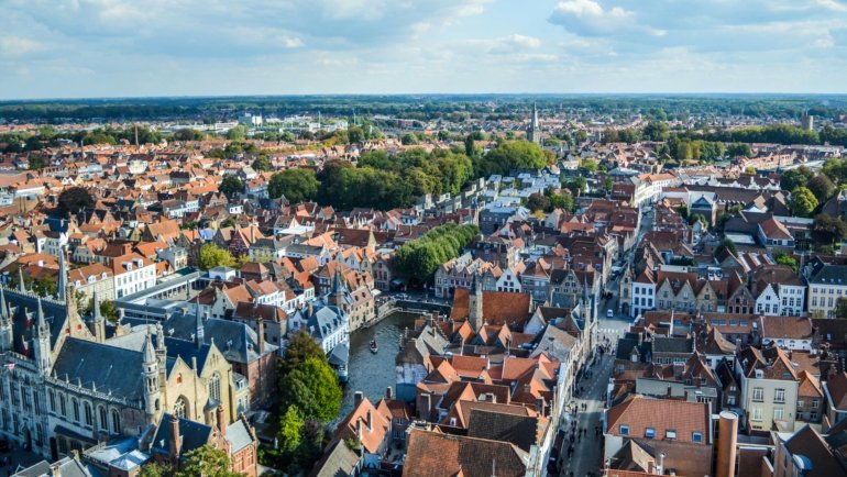 A picturesque canal in a historic city at sunrise, an example of stunning architecture that makes one of the prettiest cities in the world for travel.
