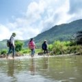 Happy people exploring a vibrant local neighborhood or serene natural park, symbolizing cool destinations near me and accessible day trip adventures.