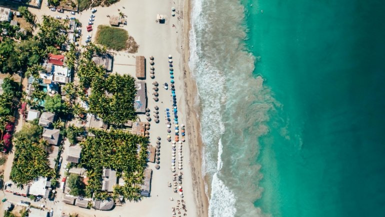 An aerial view of one of the best beaches in Mexico, featuring pristine white sand and vibrant turquoise water, an ideal destination for a 2025 getaway.
