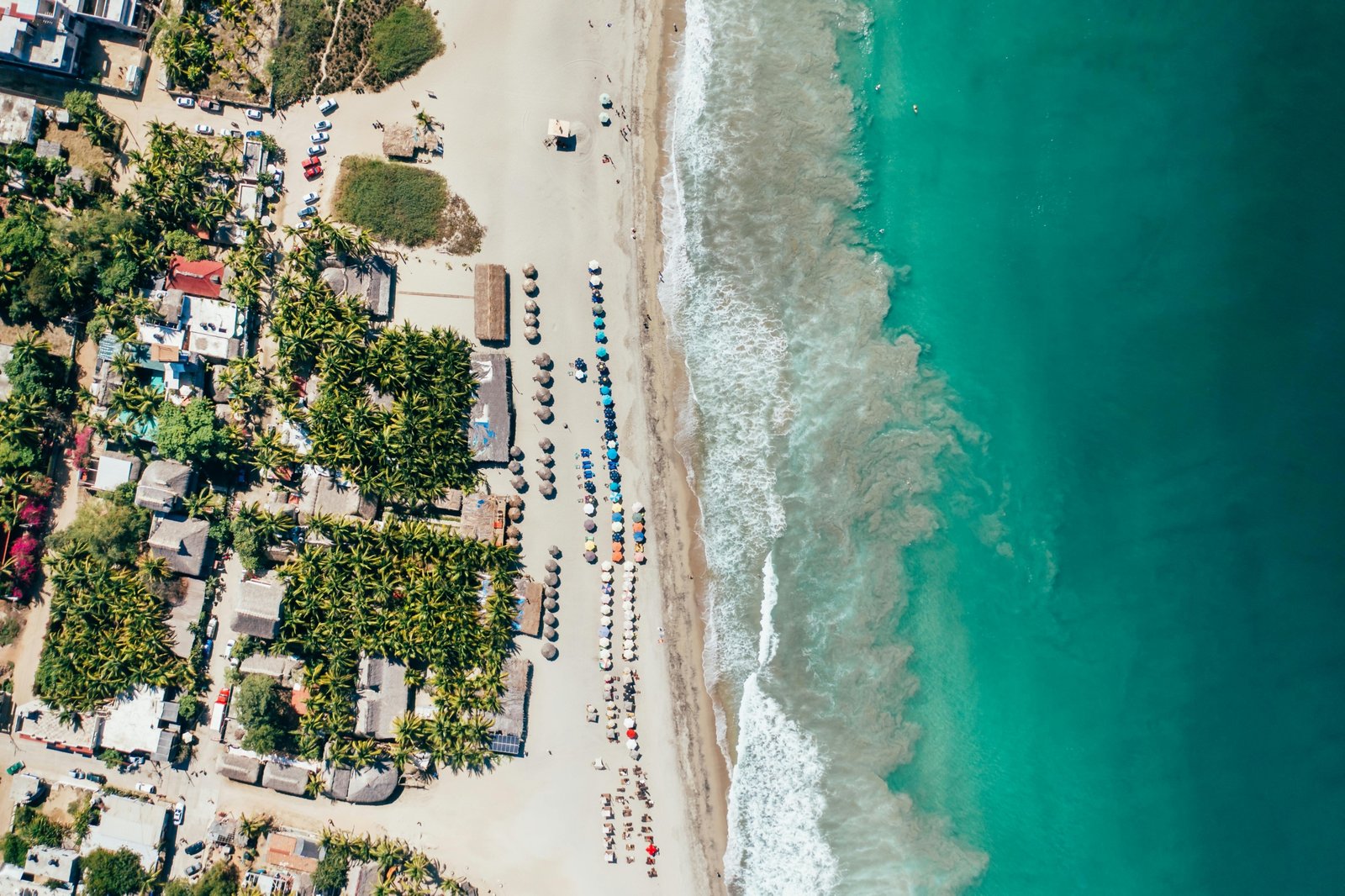 An aerial view of one of the best beaches in Mexico, featuring pristine white sand and vibrant turquoise water, an ideal destination for a 2025 getaway.