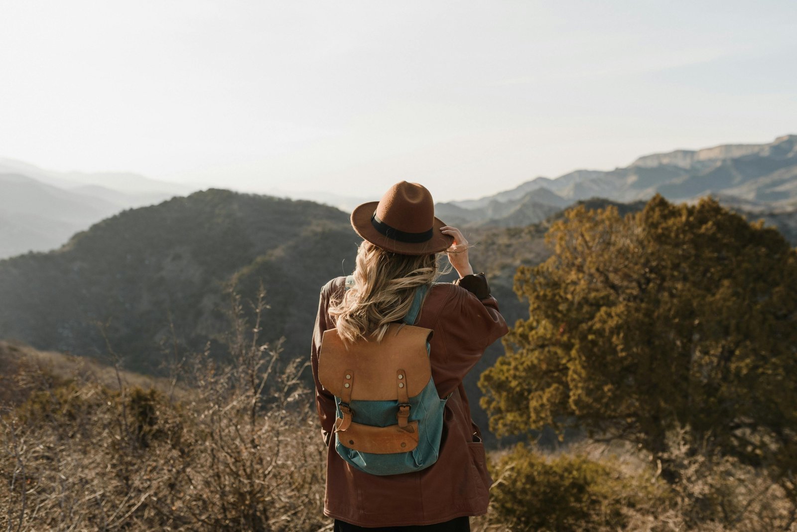 Traveler with a comfortable, carry-on compliant travel backpack exploring a vibrant city street or scenic outdoor trail, ideal for various adventures.