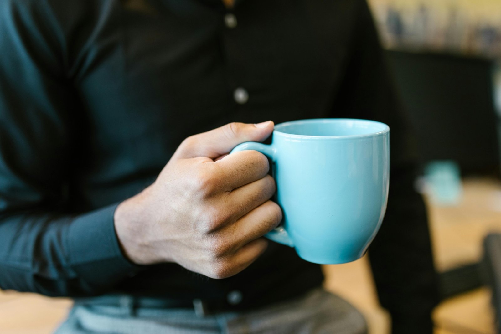 Stylish ceramic travel coffee mug held by a person during their commute, highlighting the pure taste experience and sustainable choice.