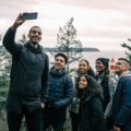 trekkersunite.com solo group travel adventure: diverse travelers connect and explore a stunning landscape with experienced guides, fostering new friendships.