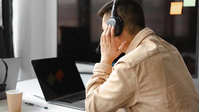 A professional travel agent efficiently using an intuitive digital itinerary builder software on a screen to create and customize detailed travel plans.
