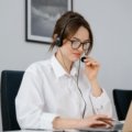 Independent travel agent confidently managing global bookings on a laptop, symbolizing the professional support and business growth offered by a travel agent host agency.