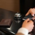Happy person using a laptop to find and book discounted hotel deals online, symbolizing smart budget travel planning and significant savings on accommodation.