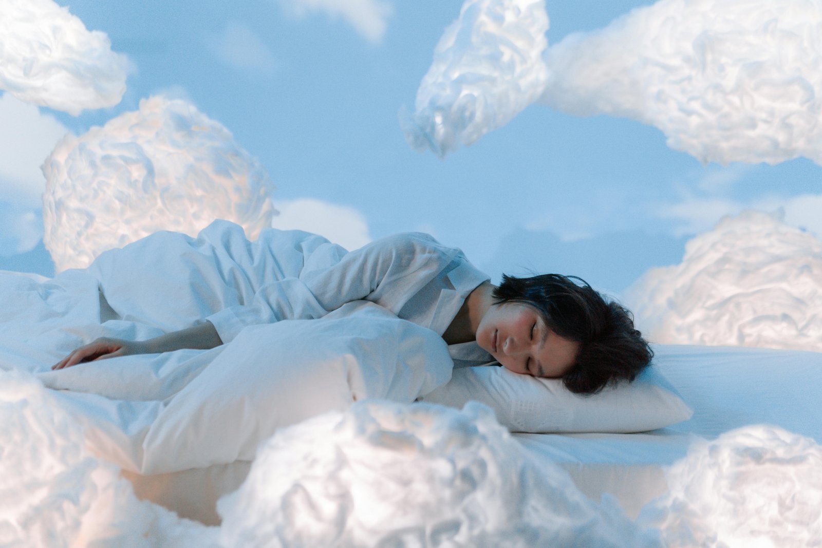 A relaxed traveler sleeping soundly on a long flight with a comfortable U-shaped memory foam travel pillow providing excellent neck support, preventing stiffness and promoting well-being for their journey.