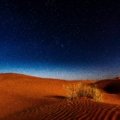 Breathtaking Milky Way over iconic orange dunes in Morocco's Sahara desert, illustrating a magical and unforgettable journey.