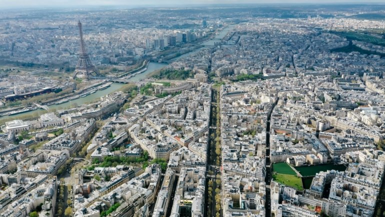A vibrant photo collage of top European cities to see, featuring famous landmarks like the Eiffel Tower in Paris, the Colosseum in Rome, and Prague's Charles Bridge.