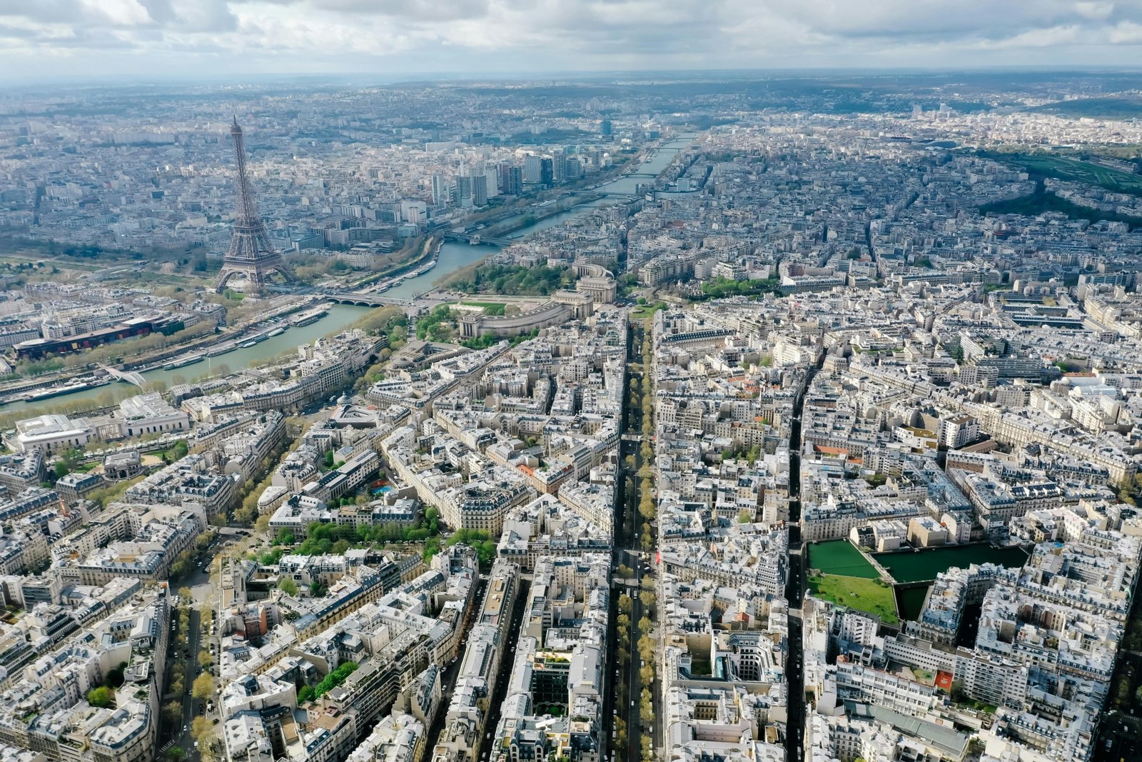 A vibrant photo collage of top European cities to see, featuring famous landmarks like the Eiffel Tower in Paris, the Colosseum in Rome, and Prague's Charles Bridge.