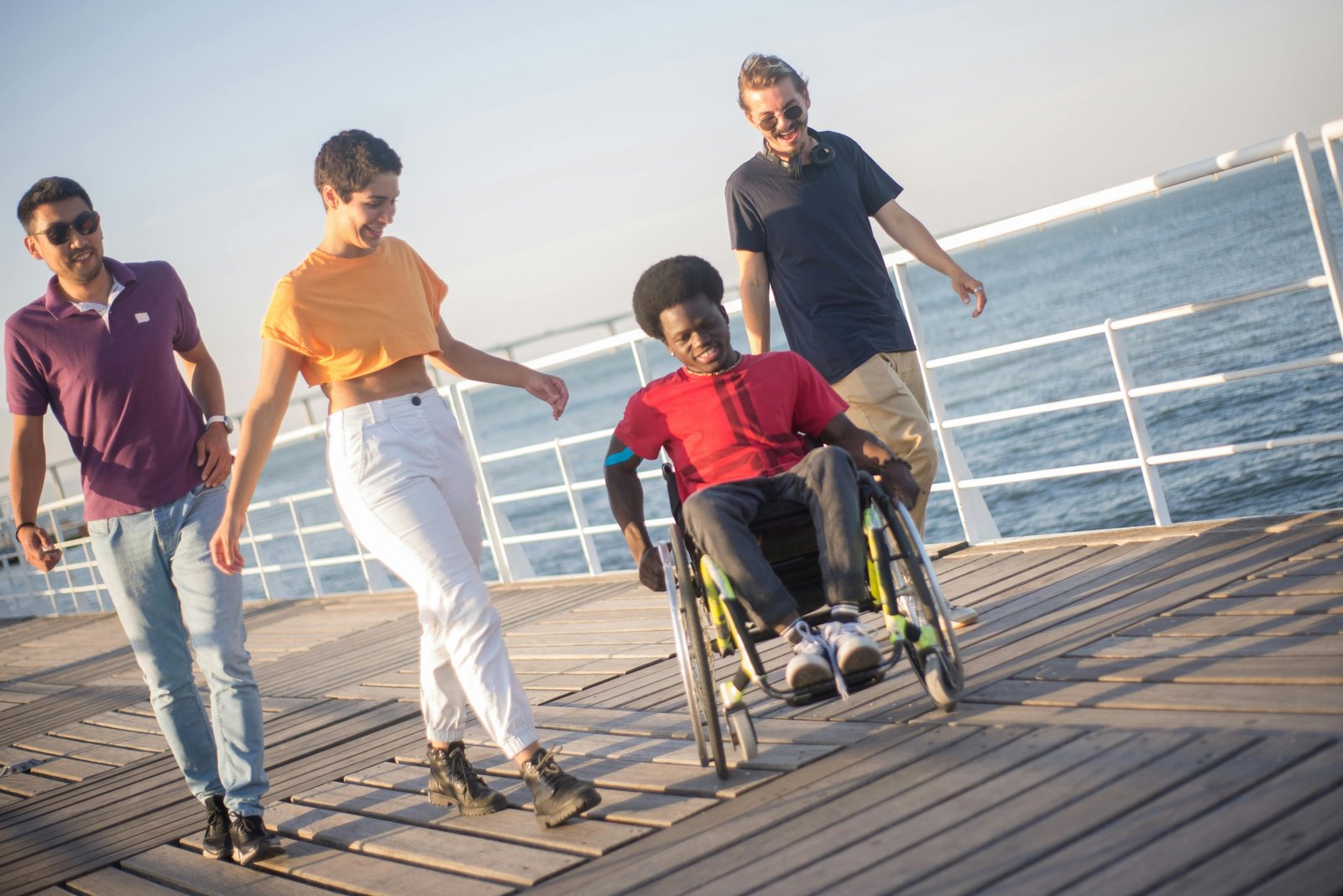 A person smiling in a lightweight, portable travel wheelchair while exploring a beautiful, accessible destination, symbolizing freedom and adventure.