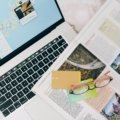 Happy traveler researching a dream trip to Spain on a laptop, utilizing an online Spain travel forum for personalized, up-to-date advice.