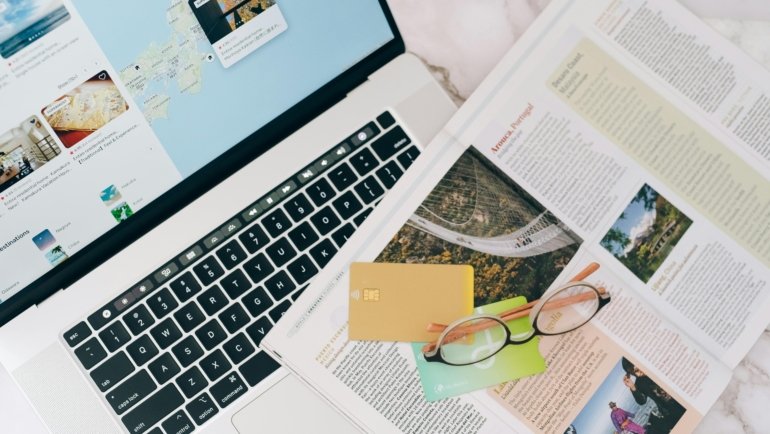 Happy traveler researching a dream trip to Spain on a laptop, utilizing an online Spain travel forum for personalized, up-to-date advice.