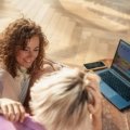 Traveler researching Swiss Alps trip on a digital device, benefiting from an online travel forum for planning and advice.