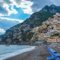Panoramic view of an idyllic beach town with a beautiful coastline and charming homes, representing the best places for coastal living and a high quality of life.