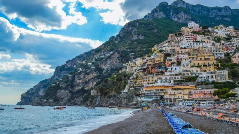 Panoramic view of an idyllic beach town with a beautiful coastline and charming homes, representing the best places for coastal living and a high quality of life.