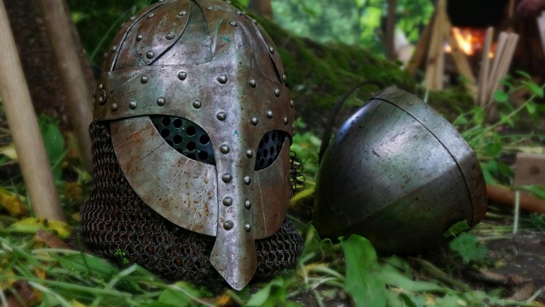 Collection of authentic historical militaria including a World War II helmet, vintage medals, and old documents, representing genuine military collectibles for discerning collectors.