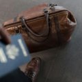 Male traveler holding an RFID-blocking travel wallet with a passport and multiple cards, showcasing secure and organized travel essentials for men.