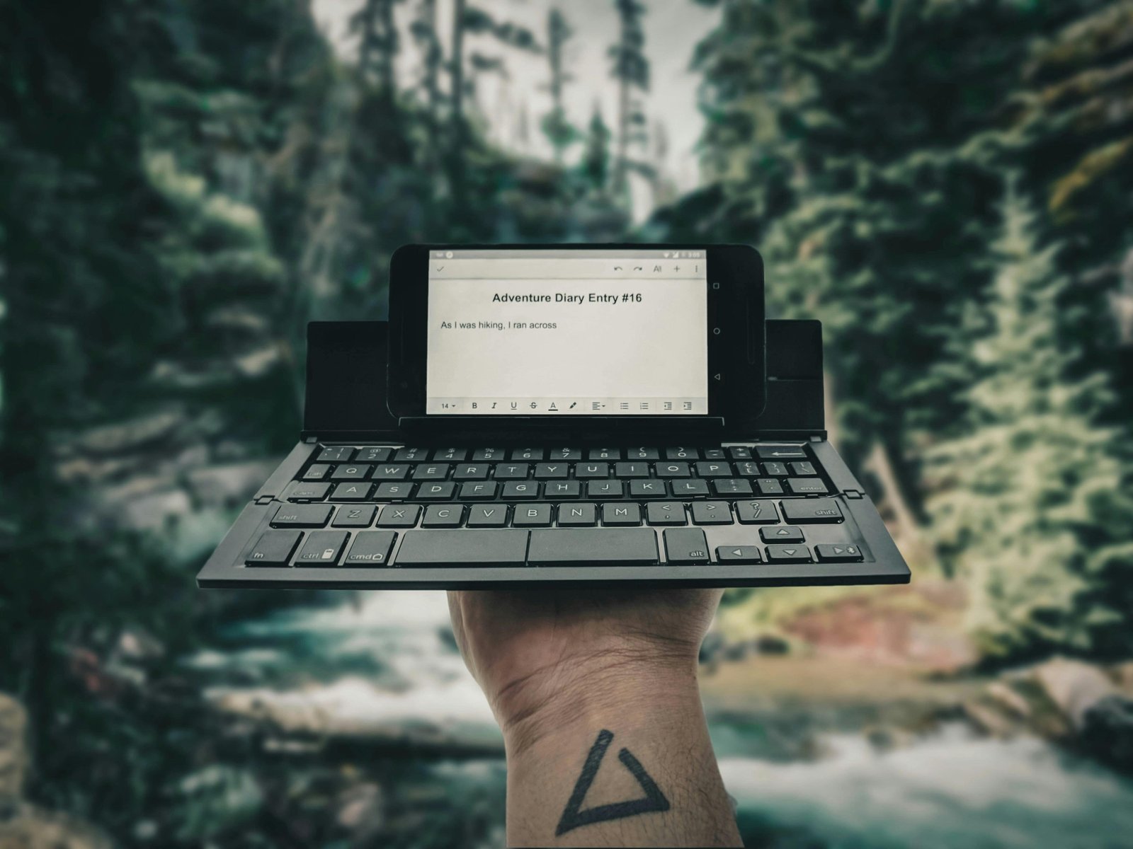 A digital nomad typing on a compact travel keyboard with a tablet, highlighting portable productivity and remote work flexibility in a travel setting.