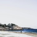 Diverse December holiday travel in the USA, featuring a split image or collage showing a sunny beach and a festive snowy town, representing varied winter vacation choices.