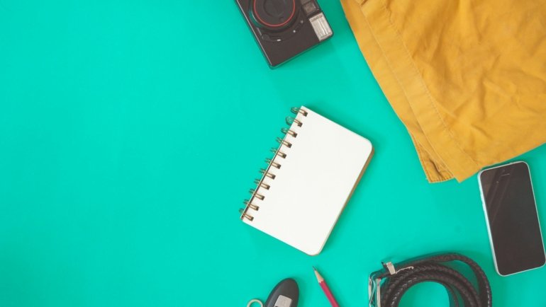 Organized travel packing essentials for a stress-free vacation, featuring a flat lay of tech gadgets, comfort items, and smart packing solutions for a memorable trip.