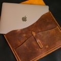 Elegant leather travel watch case securely holding a luxury watch, placed next to a passport and plane ticket, symbolizing peace of mind for valuable timepiece protection during travel.