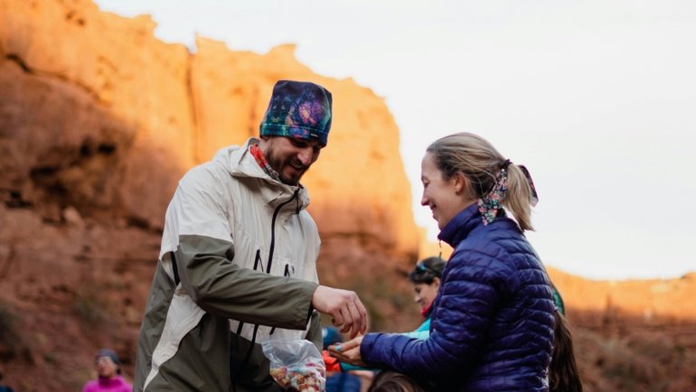 Assortment of healthy travel snacks including nuts, fresh fruit, and energy bars, neatly packed in reusable containers, ready for a sustainable and energized journey.